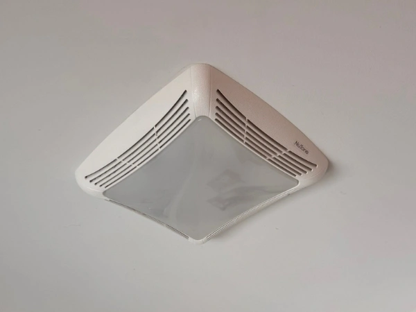 Replacement bathroom fan installed in an existing ceiling opening