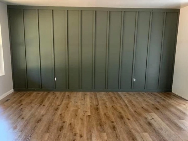 Dark paneled accent wall spanning the full room width