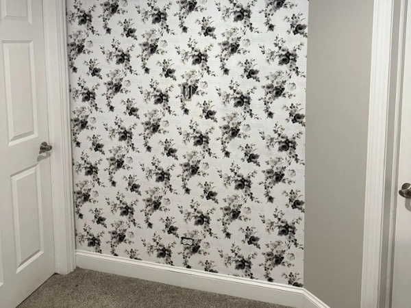 Floral wallpaper feature wall between two interior doors