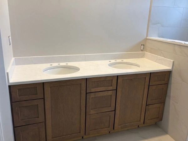Bathroom vanity with a quartz top and two sink openings
