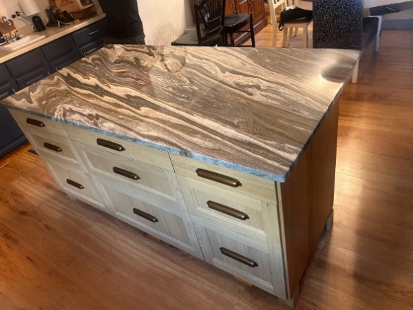 Kitchen island with a patterned natural stone top